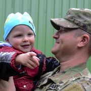 A soldier holds his young son.