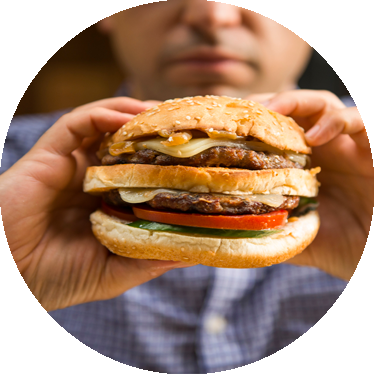 man eating cheeseburger