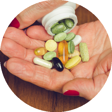 womans hand holding supplements