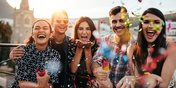 a group of friends celebrating with confetti.