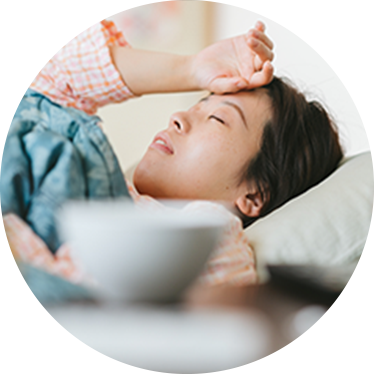 a woman laying in bed exhausted.