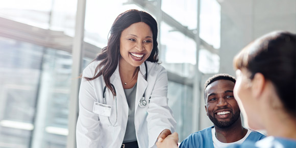 Female doctor speaking with colleagues